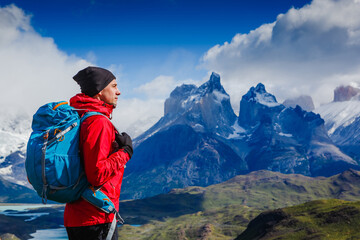 Fototapeta na wymiar Traveler with Backpack hiking in the Mountains. Travel sport lifestyle concept. Patagonia. Chile