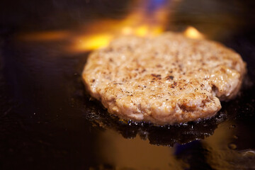 grilling meat on an iron plate