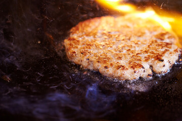 grilling meat on an iron plate