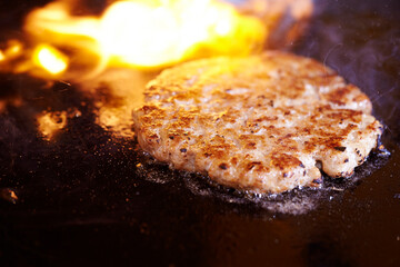 grilling meat on an iron plate