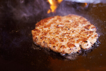 grilling meat on an iron plate