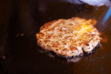 grilling meat on an iron plate