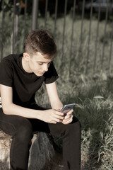 Teenage boy use a smartphone. 