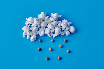White popcorn in the form of a cloud from which it rains