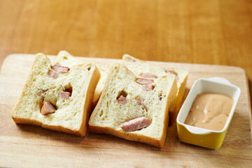 Sausage bread and sauce on a cutting board