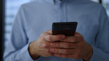 Smartphone in business man hands. Closeup businessman hands using mobile phone