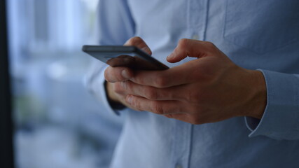 Businessman hands texting message on mobile phone. Closeup young man using phone