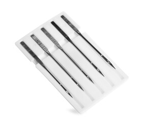 Set of metal needles for sewing machine on white background