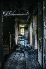 Fototapeta premium Burnt wooden house interior. Charred walls. Consequences of fire
