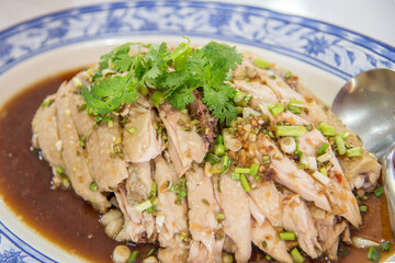 Focus on the steamed chicken with coriander on the plate.
