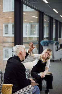 Coworkers high fiving