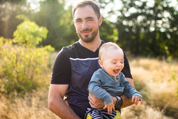 Fototapeta premium Father and his son spend time together in the park. Time for father and son. Happy father's day. Happy father burns with his son. Parental everyday life. 