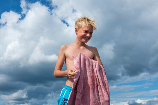Smiling boy holding towel