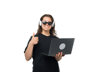 Young smiling woman is showing the thumb up while holding the laptop.