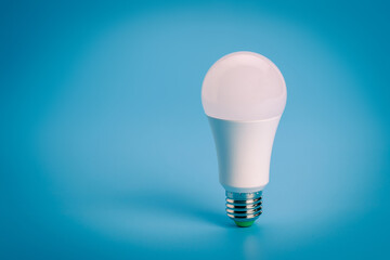 LED light bulb on blue color background.