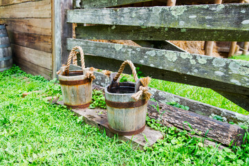 old and weathered wooden buckets with rope handle