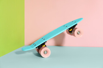 Turquoise skateboard on color background. Sport equipment