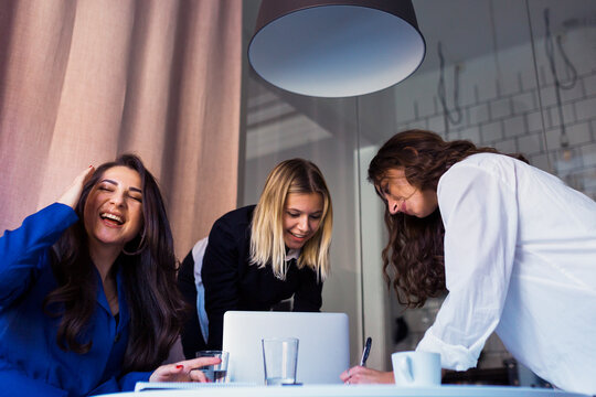 Female Coworkers Talking In Office