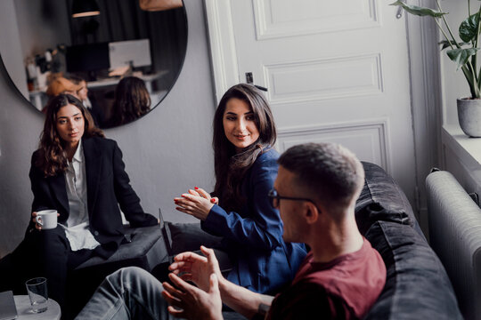 Coworkers talking in office