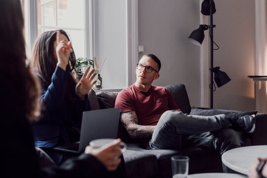 Coworkers talking in office