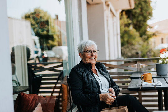 Senior woman sitting in outdoor cafe