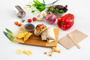 fish burrito battered with avocado, purple cabbage, corn nachos, red bell peppers, onion and garlic