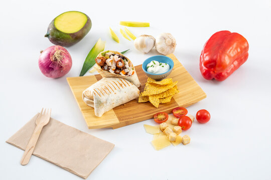Image of a seafood burrito with prawns in a raincoat, chopped surimi stick, black beans, garlic, spicy mayonnaise, corn chips, cherry tomatoes and parmesan cheese flakes