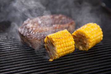 Sweet corn on the grill with ribeye beef steak