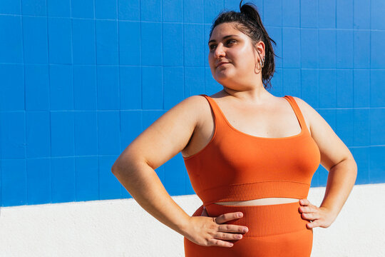 Plus size ethnic sportswoman with hands on waist