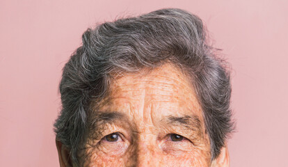 Senior woman with gray hair looking at camera