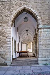 Passageway under a medieval building with arches and stone walls. Tallinn Estonia.