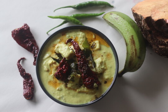 A cumin flavored yogurt based side dish with raw banana and elephant yam cooked in a coconut gravy. A main side dish of Onam meals popularly called Kalan curry.