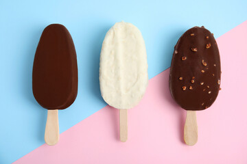 Glazed ice cream bars on color background, flat lay