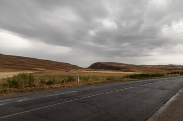 Deserted mountain road on a cloudy, grey day