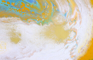 art photography of abstract marbleized effect background with white, blue and yellow reative colors. Beautiful paint.