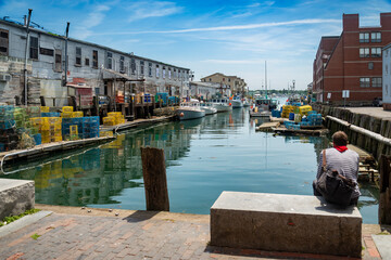 A pier filled with lobster traps and an old building, old port, in Portland, Maine.