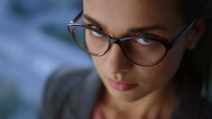 Businesswoman looking at camera in office. Entrepreneur wearing eyeglasses