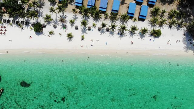 Emerald tropical sea with resort on the beach and wooden boats at lipe island