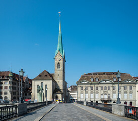 Obraz premium Zurich, Switzerland - August 20th 2021: View of Frauenmuenster church from the bridge over the Limmat river