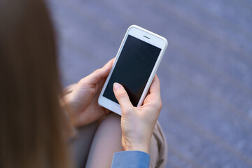 Close up woman hands holding smartphone with black screen