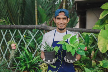 Naklejka na ściany i meble Asian man happy sell plant garden in shop