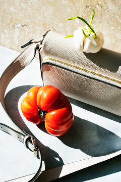 Still life with purse, garlic and tomato