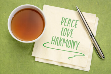 peace, love, harmony - inspirational handwriting on a napkin with a cup of coffee, spirituality, mindset and personal development concept