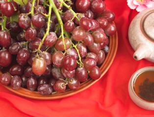 Group of Grape put beside Chinese Tea on background