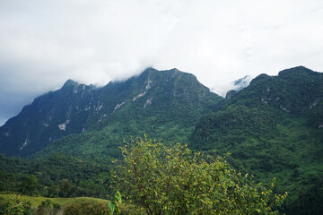 Natural landscape of green mountain range with cloudy blue sky