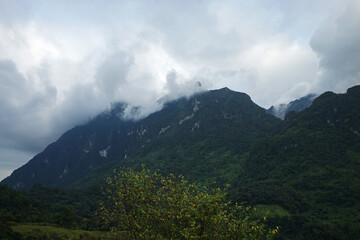 Natural landscape of green mountain range with cloudy blue sky