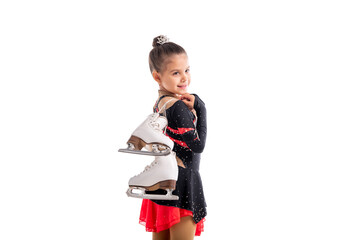 Portrait of a little girl figure skater with skates in her hands showing gesture of success