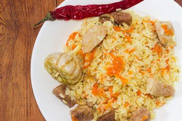 Cooked pilaf on dish, fragment top view