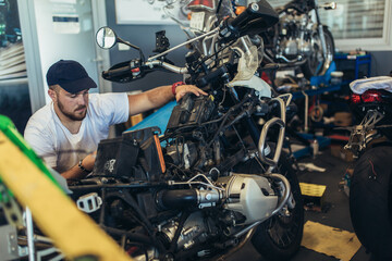 Professional motorcycle mechanic working in bike repair service