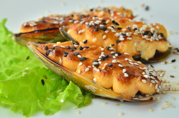 Baked Mussels under Cream Cheese with Caviar on white plate